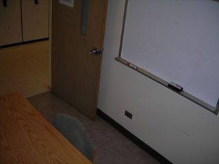 image of study room showing small table, 3 chairs white board on wall.